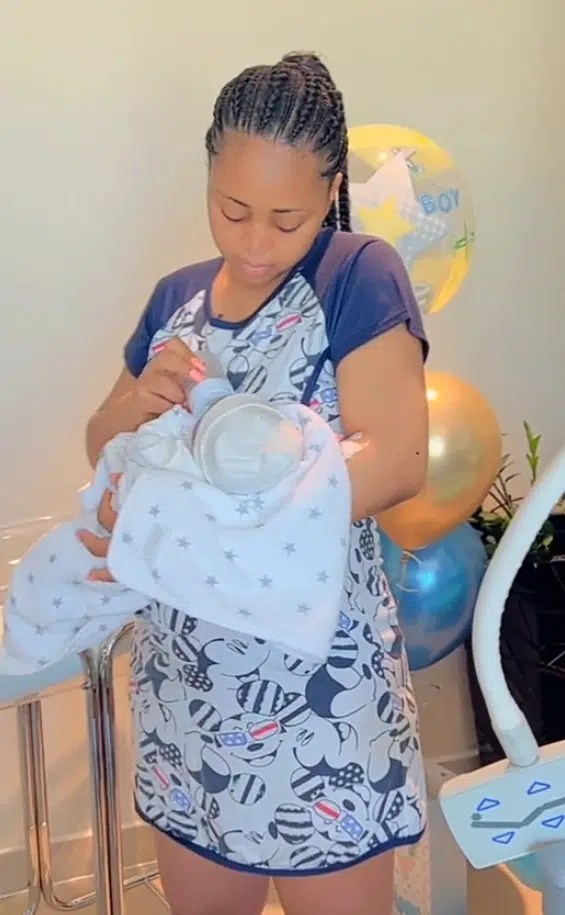 Heart melting video of Regina Daniels cradling newborn son [Video]