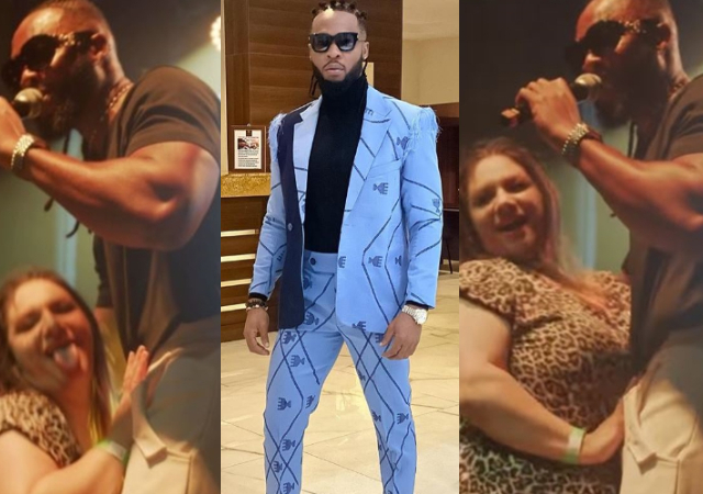 “E remain make she put hand inside trouser” –Netizen react as oyibo fan caresses Flavour on stage [Video]